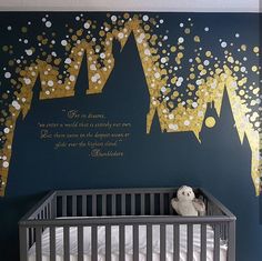 a baby's room painted with gold confetti on the walls and in front of a crib