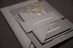 three black and gold wedding stationery with geometric designs on the front, back and sides