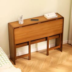 a bed room with a neatly made bed and a wooden dresser