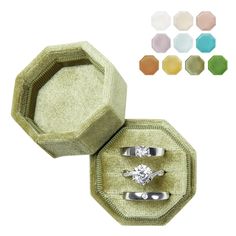 an open ring box with two rings inside and four different colors on the sides, including one