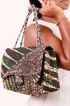 Carry all your essentials for work, travel, or a night out in this gorgeous and unique African Quilted Handbag. This light bag is made of African print with allover V-shaped quilted stitch details for a luxe look and a chain that can be carried as single or double. The Interior accessory and pockets help you keep items organized in your purse, while an exterior slip pocket offers convenient access to things you want to keep close at hand. Plus, a top closure tab keeps the contents of your purse Large Capacity Rectangular Bags As Fashion Accessory, Large Capacity Rectangular Bag As Fashion Accessory, Chic Travel Shoulder Bag With Removable Pouch, Satchel Box Bag With Removable Pouch, Fashion Accessory Satchel Box Bag With Removable Pouch, Crossbody Bag With Removable Pouch, Luxury Multicolor Shoulder Bag For Travel, Rectangular Satchel With Magnetic Closure For On-the-go, Luxury Brown Flap Bag With Large Capacity