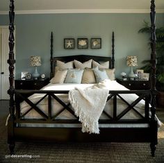 a bedroom with a four post bed and blue walls