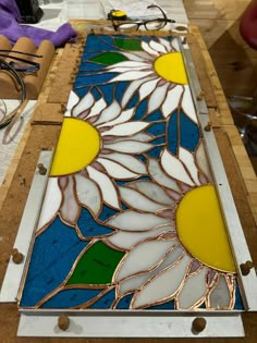 the stained glass is being worked on with wood and glues to make it look like flowers