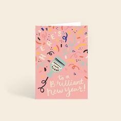 a pink greeting card with scissors and confetti on it, says happy new year