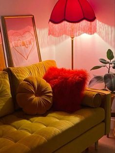 a living room with a couch, lamp and pictures on the wall