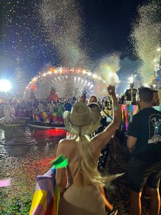 people watching fireworks being thrown in the air at an amusement park or fairground during the day