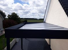 the roof of a house with a metal gutter attached to it