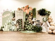 an assortment of decorative items displayed in front of a wall with animals and plants on it