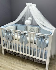 a baby crib with blue and white bedding