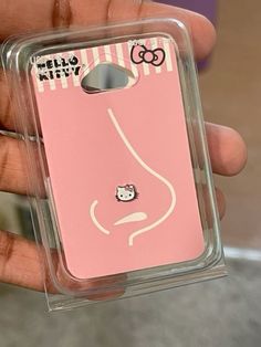 a person holding up a pink case with a hello kitty on it