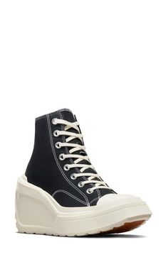 "Find CONVERSE Chuck 70 De Luxe High Top Wedge Sneaker on Editorialist. A lightweight wedge heel and platform boost this fierce rewrite of an iconic high-top sneaker outfitted with a canvas upper and lug sole for durability. 4 1/2\" heel; 2\" platform (size 8.5) 3 3/4\" shaft Lace-up style Textile upper and lining/rubber sole Imported" Mid-top Platform Sneakers For Streetwear With Lug Sole, Mid-top Platform Sneakers With Lug Sole For Streetwear, Sporty High-top Platform Sneakers With Chunky Platform, Casual High-top Platform Boots With Thick Bottom, High-top Sneakers With Chunky Platform And White Sole, Trendy High-top Wedge Sneakers With Chunky Platform, Chunky Platform High-top Sneakers For Streetwear, Casual High-top Wedge Sneakers With Lug Sole, High-top Platform Sneakers With Lug Sole