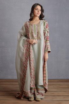 Sage green kurta with placement embroidery, chintz printed motifs and round neckline. Paired with printed, embroidered pant and printed dupatta.
Component: 3
Pattern: Printed
Type Of Work: Chintz
Neckline: Round
Sleeve Type: Long Sleeves
Fabric: Kurta and Pant: Pure Linen, Handwoven Chanderi; Dupatta: Silk Organza, Handwoven Chanderi
Color: Green
Other Details: 
Tassel hem
Placement embroidery
Chintz print
Printed pant
Occasion: Destination Wedding - Aza Fashions Desi Clothes, Embroidered Pants, Designer Party Wear Dresses, Sharara Set, Stylish Dresses For Girls, Pakistani Dress Design, Stylish Dress Designs, Designer Dresses Indian, Silk Organza