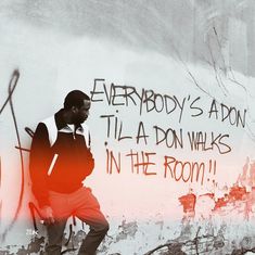 a man standing in front of a wall with graffiti on it that says everybody's aaron tila don walks in the room