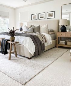 a bedroom with a large bed and white carpet