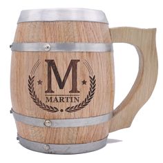 a wooden beer mug with the letter m on it and a metal band around the handle