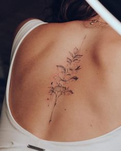 a woman with a flower tattoo on her back