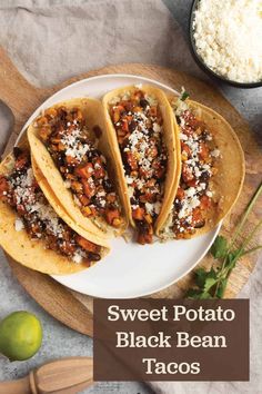 three tacos are sitting on a plate next to some rice