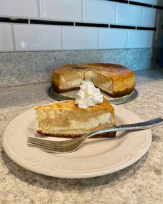 two slices of cheesecake sitting on top of a white plate with a silver fork