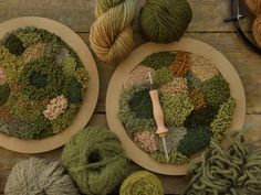 two plates with yarn and skeins on top of a wooden table next to knitting needles