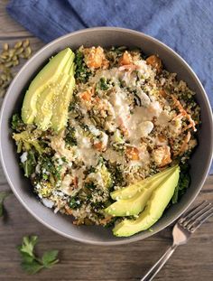 a bowl filled with rice, broccoli and avocado