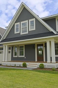 a gray house with white trim and windows