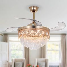 a chandelier hanging from the ceiling in a room with white walls and furniture