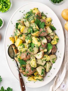 a white plate topped with potatoes and parsley