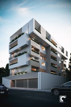 an apartment building with balconies and plants on the top floor, next to a street