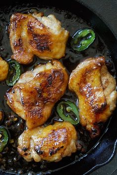 chicken and peppers cooking in a skillet