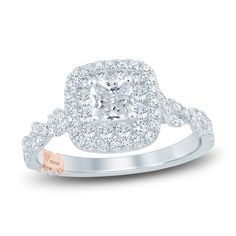 a cushion cut diamond ring with two rows of diamonds on the band