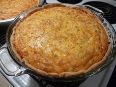 two pies sitting on top of an oven next to each other in pans