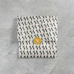 the monogrammed pocketbook cover has a gold initial on it and is printed with black letters