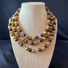 "This listing is for a Coro signed three strand necklace.  The necklace has mostly resin beads in colors of brown with gold splashes, beige, and clear faceted glass.  The necklace also has gold details and a hook clasp. Size:  Approximately 14\" to 17-1/2\" with an additional 2-1/2\" extension Condition:  Good condition for being vintage Want to purchase 3 or more items from my shop?  Please use the following coupon when you check out to receive 20% off! https://www.etsy.com/shop/elsysvintage?co Brown Multi-strand Beaded Necklace With Gold Beads, Brown Gold Beads Multi-strand Necklace, Brown Multi-strand Necklace With Polished Beads, Brown Polished Beads Costume Jewelry Necklace, Vintage Brown Necklace For Party, Vintage Brown Necklaces For Party, Brown Polished Bead Costume Necklace, Brown Polished Beads Costume Necklace, Brown Multi-strand Beaded Necklaces