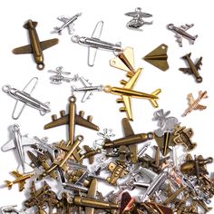 a pile of assorted metal objects on a white surface with clippings to the side