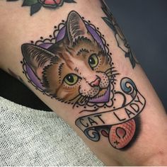 a close up of a cat tattoo on a person's leg