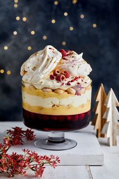 a layered dessert with whipped cream and cranberries