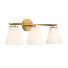 three light bathroom fixture with white glass shades on an antique brass finish wall mounted lamp