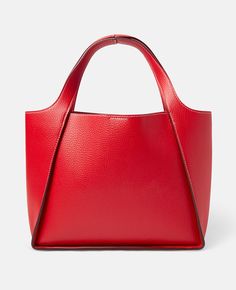 In a bold, notice-me shade of bright red, this Stella Logo crossbody tote bag is an escapist, timeless design. Consciously crafted from Alter Mat, a smooth and butter-soft vegan alternative to leather, the tote has two top handles along with a crossbody strap for adaptable wearing. Perforated Stella McCartney logo on front Grained Eco Alter Mat vegan alternative to animal leather Contrast single stitching Two top handles Adjustable crossbody strap Stainless steel and recycled brass hardware Deta Stella Logo, Stella Mccartney Logo, Vegan Alternatives, Crossbody Tote Bag, Crossbody Tote, Brass Hardware, Crossbody Strap, Bright Red, Stella Mccartney