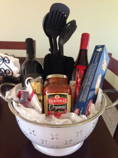 a white colander filled with condiments and cooking utensils