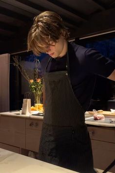 a woman in an apron is preparing food