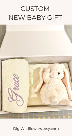 a baby gift box with a stuffed bunny in it and the words, custom new baby gift