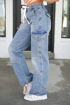 A forever classic denim with an elevated touch, these statement-making jeans have all the pockets, finally! Denim-Cargo-Drawstring-Pants have a cute drawstring waist and fading throughout. A relaxed, straight-leg fit will make this the ultimate jean for casual style. Model is 5’7” wearing a size small Total Length of a small is 41" Inseam of a small is 30.5" 90% Cotton, 10% Polyester SIZE US WAIST HIPS S 3-5 26"-27" 35"-36" M 7-9 28"-29" 37"-38" L 11-13 30"-31" 39" XL 15 32" 41" Making Jeans, Denim Cargo, Drawstring Pants, Denim Pants, Drawstring Waist, Casual Style, Denim Jeans, Straight Leg, Pants For Women