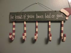 a sign that says he knows if you've been bad or good hanging on the wall