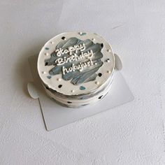 a birthday cake is sitting on top of a card