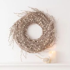 a close up of a wreath made out of twigs on a white background with space for text