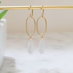 This beautiful pair of handmade earrings feature 2 White Opal gemstones. The earrings are handmade using nickel-free 14k Gold Filled or Sterling Silver. These earrings are simple and dainty, perfect for everyday wear. Makes a great gift to add to any gemstone lover's collection. Perfect to gift for Christmas, Valentine's Day, Mother's Day, and more! Gemstone: White Opal, Simulated Gemstone Size: 16.0 X 6.0 mm Metal: 14k Gold Filled or Sterling Silver (Hypoallergenic) Shape: Elongated Teardrop, H Oval Hypoallergenic Teardrop Earrings As Gift, Hypoallergenic Oval Teardrop Earrings For Gifts, Dainty Oval Earrings For Everyday, 14k Gold Filled Oval Earrings With Ear Wire, Elegant Everyday Gemstone Teardrop Earrings, White Oval Minimalist Earrings, Minimalist White Oval Earrings, Oval 14k Gold-filled Earrings With Ear Wire, Handmade Oval 14k Gold Filled Earrings