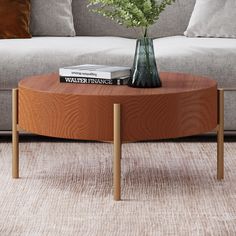 a coffee table with books on it and flowers in a vase sitting on the top