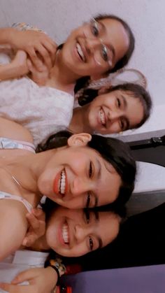 three women are smiling and posing for the camera