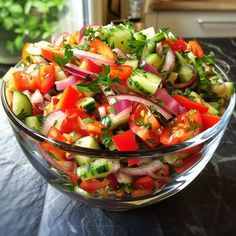 a glass bowl filled with lots of veggies