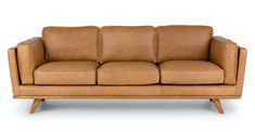 a brown leather couch sitting on top of a white floor